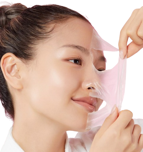 Person applying a pink face mask to their face